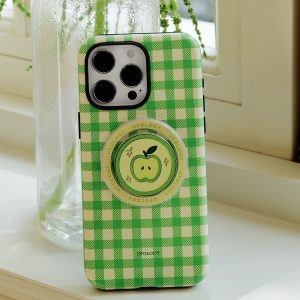 The green gingham case standing on a windowsill beside a clear glass bottle