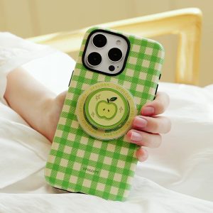 Hands holding the green check case above white bedding, apple holder facing up