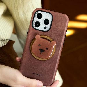 Hands holding the brown grained case with the bear head facing out, warm lamp behind