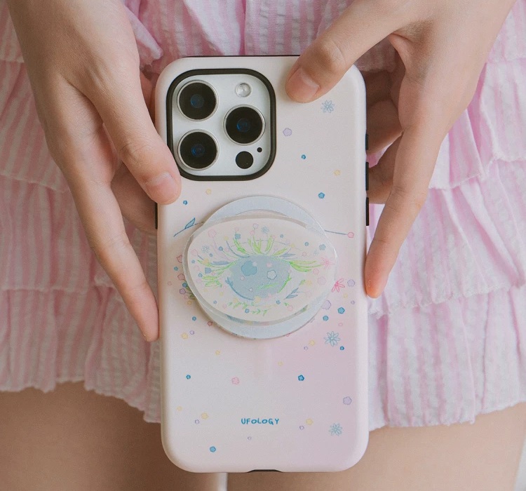 Hands holding the blush case with the clear holder mounted over the drawn eye
