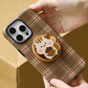 Two hands holding the brown tartan chipmunk case above a cardboard box