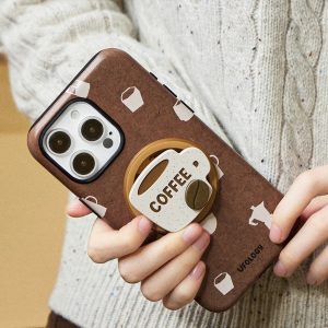 The case tilted forward in both hands, cup holder and printed pattern catching the light