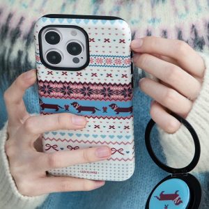 Winter knit case held in both hands over a cream jumper