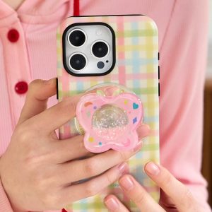 Pastel check case held in one hand against a pink cardigan