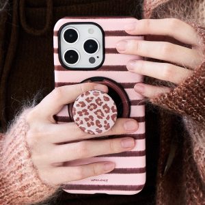 Hands holding the pink striped case, thumb resting in the leopard-print holder