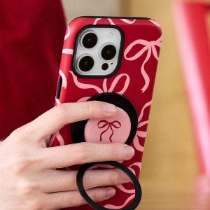 Deep red ribbon case held in one hand with the ring stand open