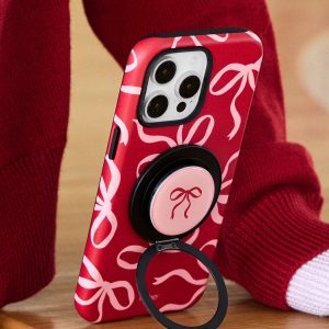 Red bow-print case standing upright against a red knit sleeve