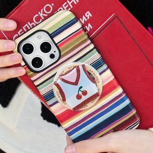 Striped case tilted against a red book, showing the vest holder from an angle