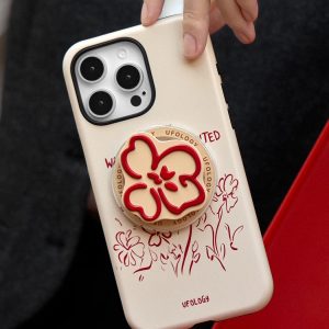 Red line-drawn flower case lifted by one hand over a red chair