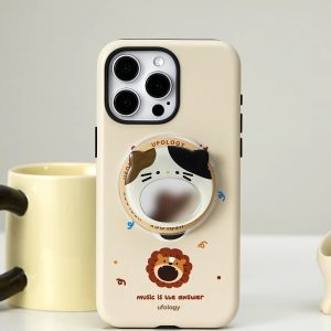 Cream lion case standing beside a yellow mug with the calico cat mirror holder attached