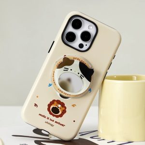 Singing lion case leaning on a mug, the cat mirror holder catching the light