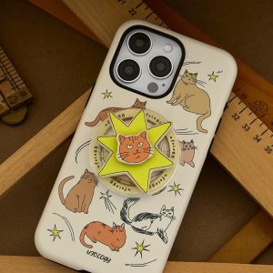 Cat-print phone case resting on a wooden desk beside a ruler