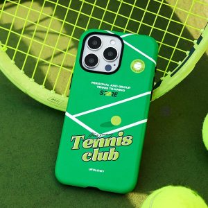 Green tennis case propped on a racket beside two tennis balls, holder removed