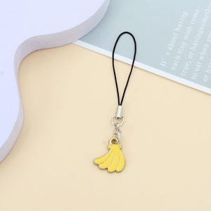Banana phone charm, a small yellow enamel banana bunch on a short black cord loop – styled shot