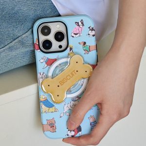 Hand holding the blue dog print case with the biscuit holder over denim
