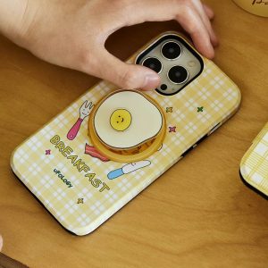 Breakfast case lying on a wooden table, fried egg holder clipped on