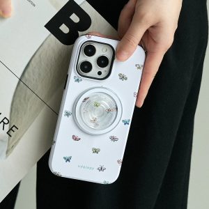 Hand holding the lilac butterflies case with the clear holder over a magazine