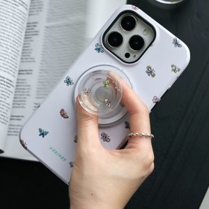 Fingers turning the clear butterfly holder on the lilac iPhone case