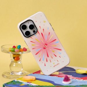 Cream starburst iPhone case without the holder, leaning on a glass of jelly beans
