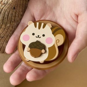 Hand holding the chipmunk grip so the acorn and pink cheeks face up