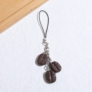 Coffee bean phone charm, three dark brown coffee beans on a short black cord loop – styled shot