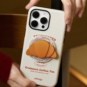 Croissant grip attached to the back of a cream croissant phone case