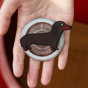 Open hand holding the dachshund grip so the long brown dog faces outward
