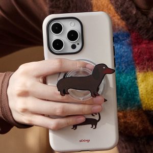 Dachshund grip attached to the back of a cream phone case held in a hand