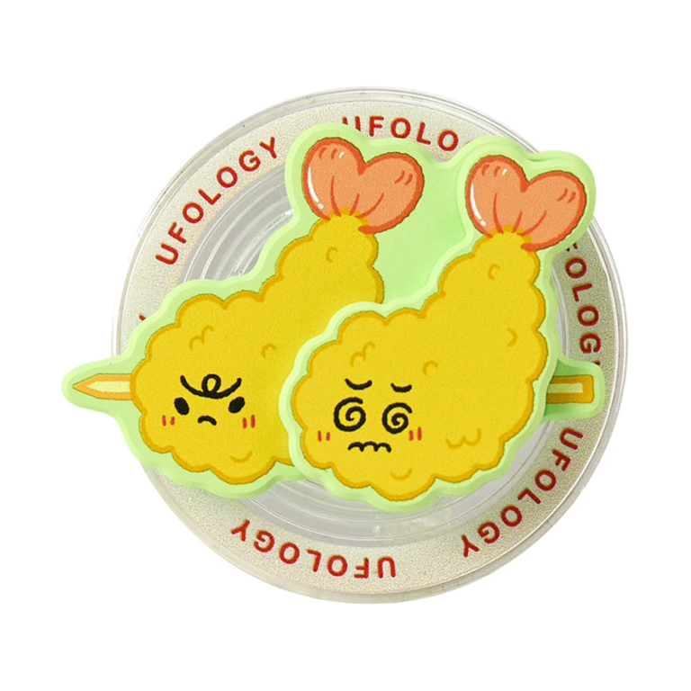Fried shrimp MagSafe phone grip, two golden fried shrimp with funny faces on a clear base
