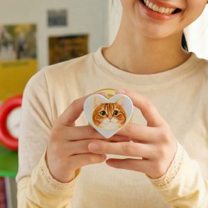 Woman holding the ginger cat grip in both hands