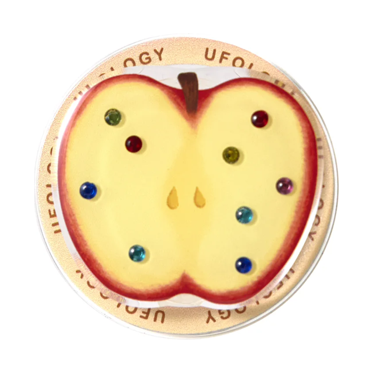 Jewel apple MagSafe phone grip, a halved apple set with colored gems on a clear base