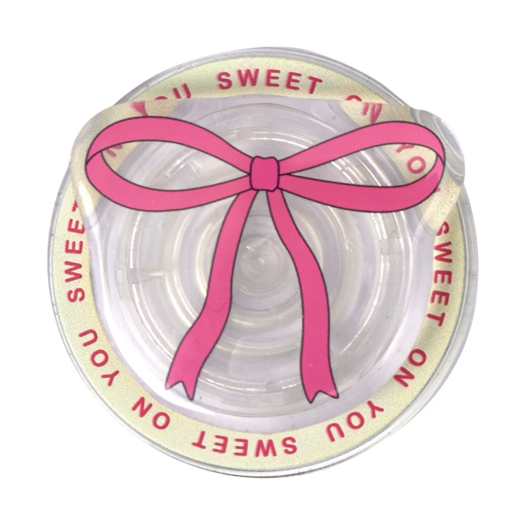 Pink bow MagSafe phone grip, a pink ribbon bow on a clear disc with Sweet on You lettering