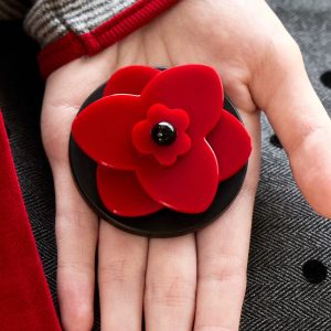 Open hand holding the red blossom grip against a red sleeve