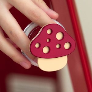 Hand holding the red mushroom grip beside a red door