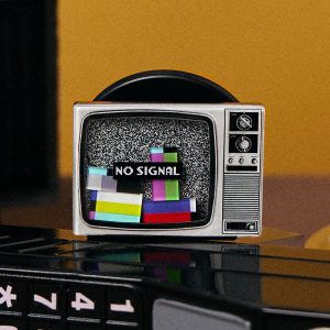 Retro TV grip standing on a black telephone keypad