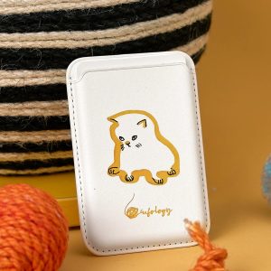 Sad cat MagSafe wallet, a cream card wallet with a gloomy golden-brown outline cat – styled shot