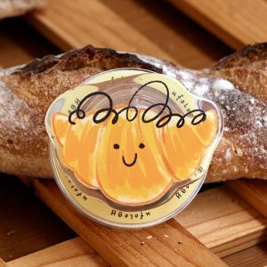 Smiling bun grip resting on a loaf of crusty bread