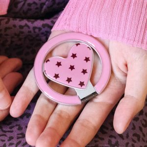 Open hand holding the starry heart grip with its ring folded out