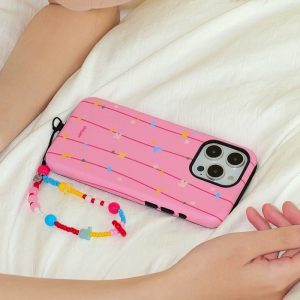 Tidal sea charm hanging from a pink striped phone case on a white bed