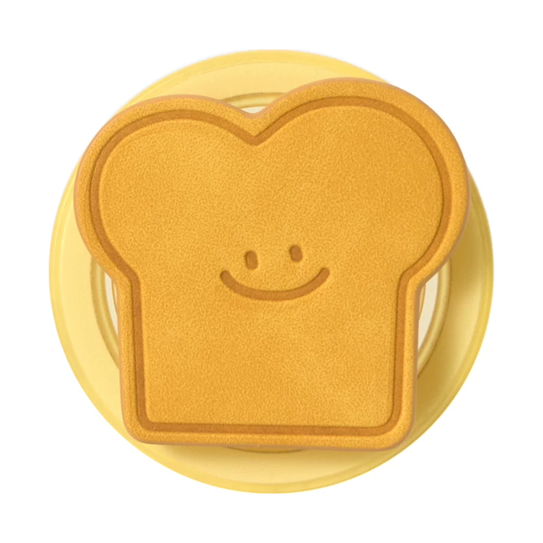 Toast MagSafe phone grip, a smiling golden slice of toast on a butter-yellow round base
