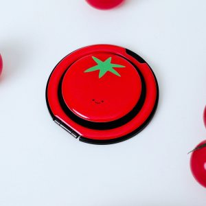 Tomato grip on a white table among red cherry tomatoes