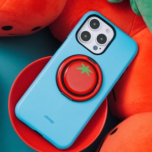 Tomato grip on the back of a sky blue phone case among plush vegetables