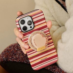 Striped iPhone case with mitten holder held against a cream knit sweater
